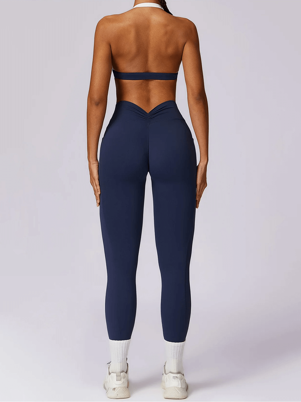 Back view of women's navy yoga set with sleeveless top and high-waist leggings, designed for fitness, flexibility, and style.